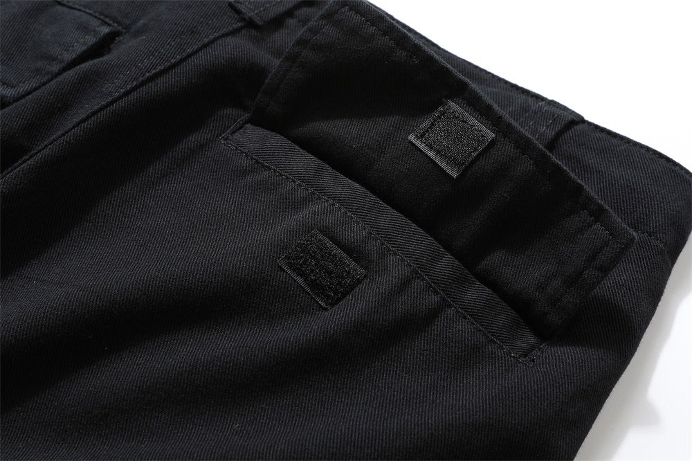 close-up of black cargo pants waist with velcro fastening tactical design detail