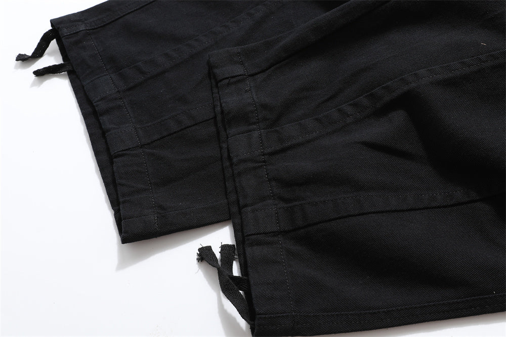 close-up of black cargo pants leg opening with drawstring adjustable fit detail