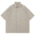 Beige and white striped shirt with a pocket on a white background