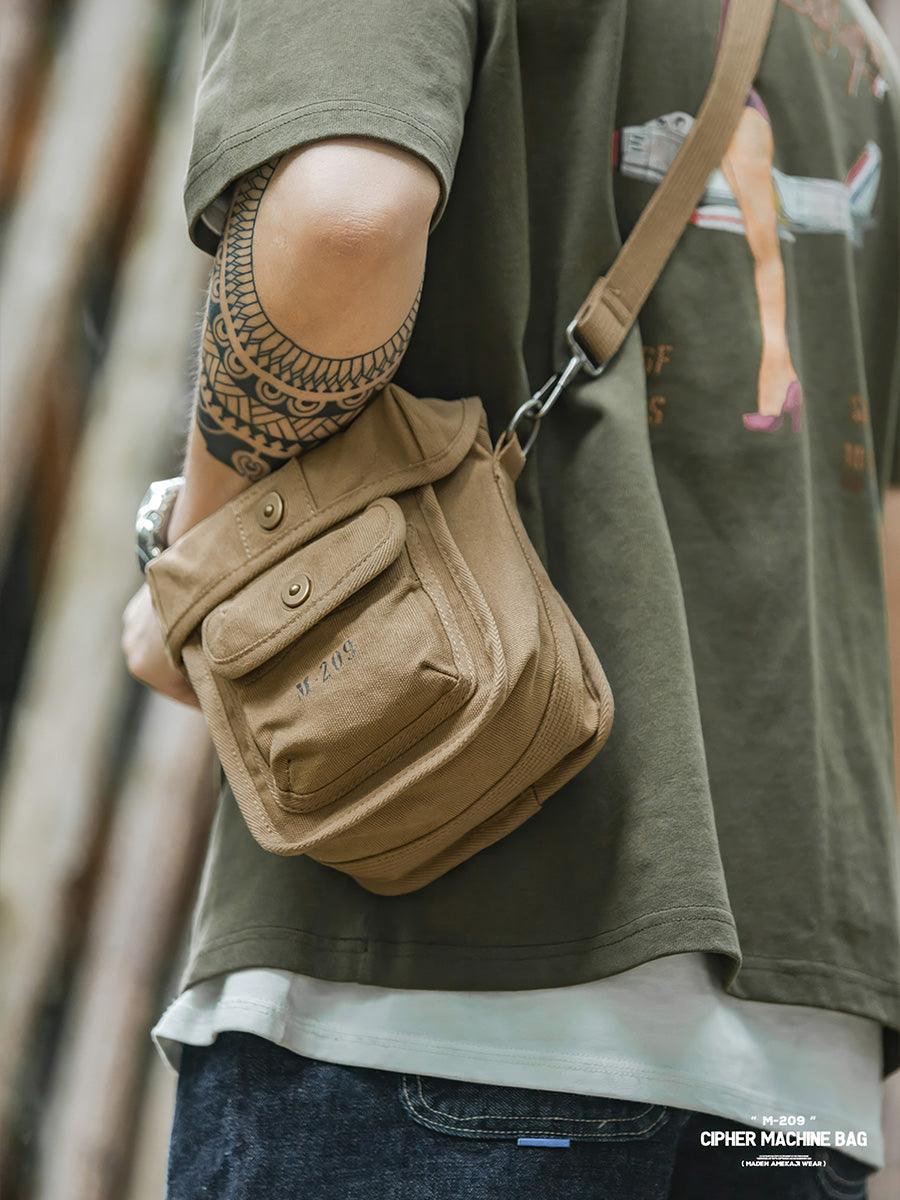 WWII inspired M-209 military canvas crossbody bag worn with casual streetwear style